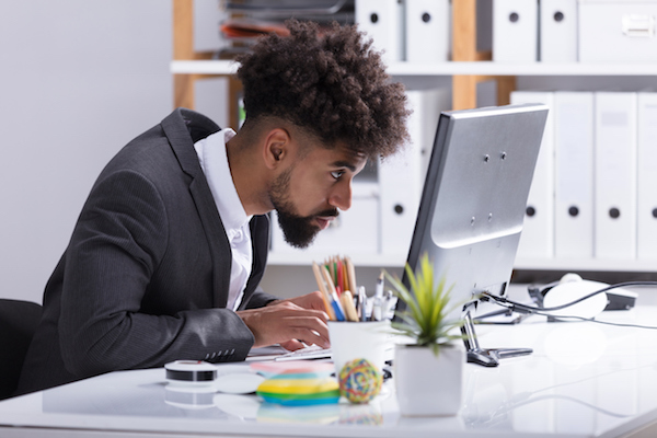 seated office worker leaning forward with poor posture